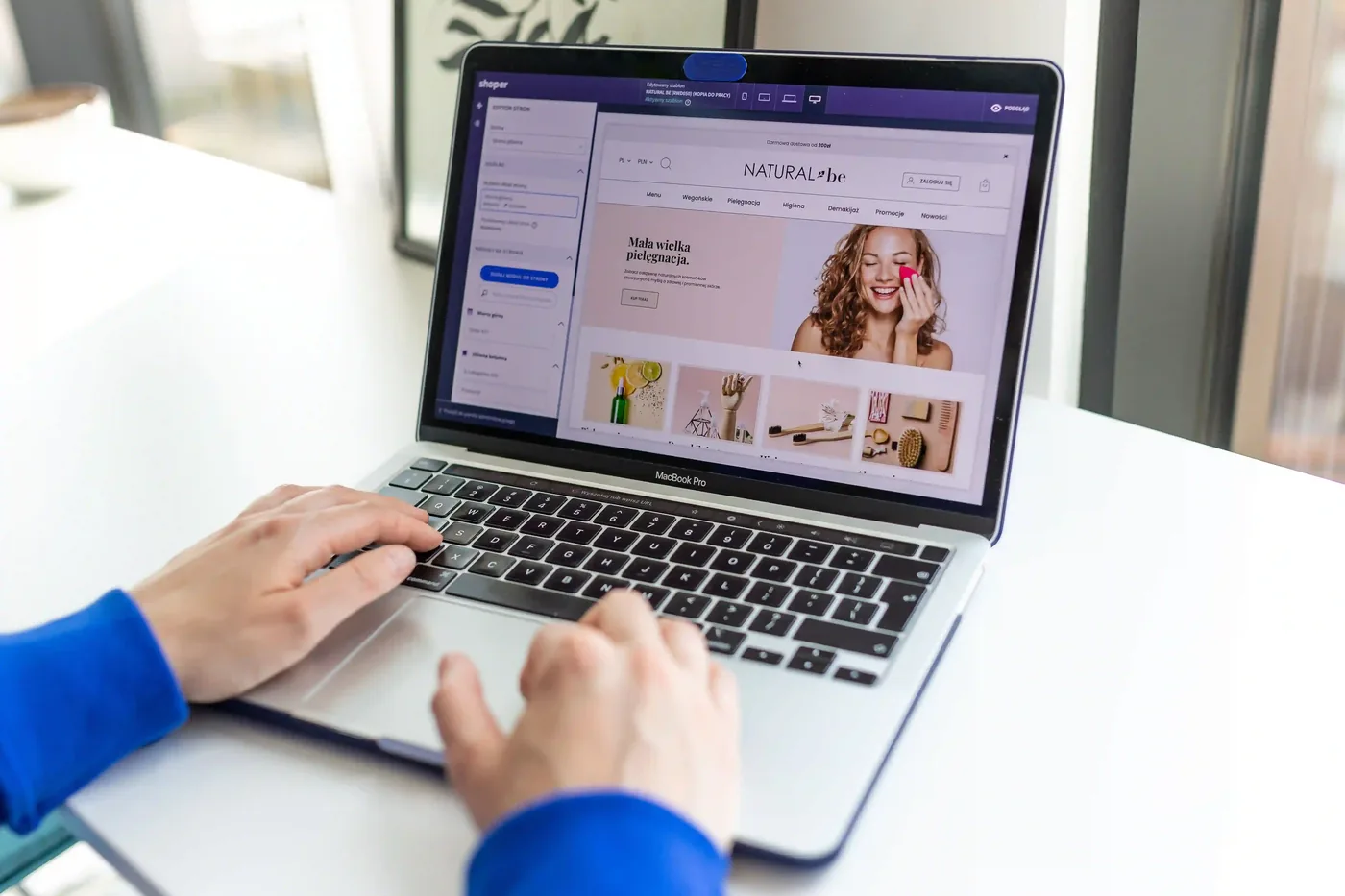 Webshopeigenaar werkt aan de inrichting van zijn webshop op een laptop